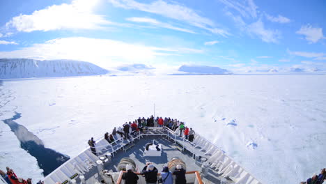A-POV-time-lapse-shot-of-a-ship-bow-icebergs-and-tourists-passing-through-Lomfjorden-near-Svalbard-Norway-1
