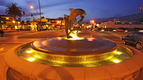 Traveling-time-lapse-shot-of-the-dolphin-fountain-near-State-Street-in-downtown-Santa-Barbara-California