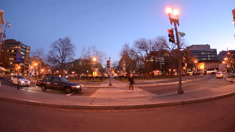Time-lapse-of-people-using-a-crosswalk-during-rush-hour-traffic-at-dusk-in-Dupont-Circle-in-Washington-DC