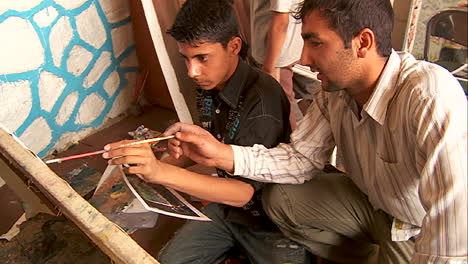 Two-boys-work-on-a-painting-at-an-art-school-in-Kabul-Afghanistan