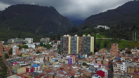 Lowering-aerial-establishing-shot-of-old-buildings-modern-skyscrapers-and-neighborhoods-in-downtown-Bogota-Colombia