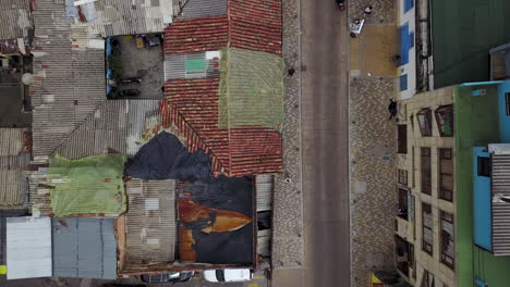 Aerial-establishing-shot-looking-straight-down-of-a-red-tile-roofed-neighborhood-and-streets-in-Bogota-Colombia