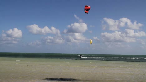 People-engage-in-the-fast-moving-sport-kite-boarding--along-a-sunny-coast-2