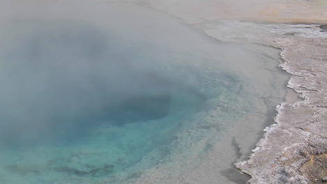 Steam-Rises-From-A-Geothermal-Pool-In-Yellowstone-National-Park-2