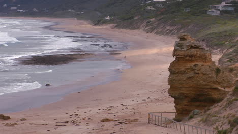 A-Person-Walks-Along-A-Lonely-But-Scenic-Beach