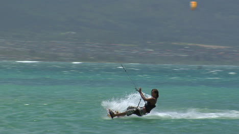 A-Windsurfer-Glides-Across-The-Ocean-And-Wipes-Out-After-A-Stunt