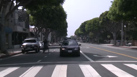 A-Car-Travels-Along-A-Street-In-Santa-Monica-California-As-Seen-Through-The-Rear-Window