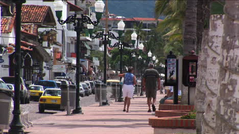 Pedestrians-walk-on-a-sidewalk