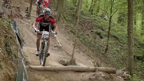 Cyclist-race-along-a-rough-dirt-road-course