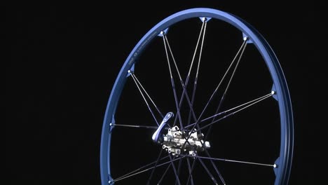 A-blue-bicycle-rim-rotates-around