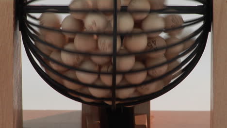 Closeup-of-bingo-balls-spinning-in-a-bingo-cage