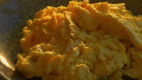 A-slow-pull-into-a-bowl-of-scrambled-eggs
