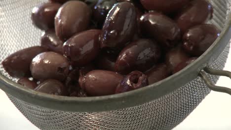 A-vertical-pan-of-olives-in-a-strainer