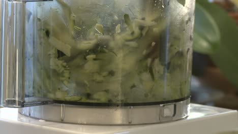 Close-up-of-zucchini-being-chopped-in-a-food-processor