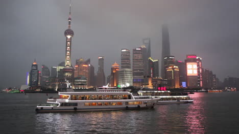 The-vivid-night-skyline-of-Shanghai-China-with-river-traffic-foreground-1