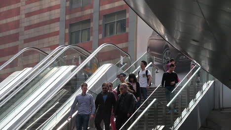 Asian-businesspeople-ride-a-modern-escalator