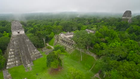 Great-aerial-shot-over-the-Tikal-pyramids-in-Guatemala-2