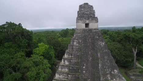 Great-aerial-shot-over-the-Tikal-pyramids-in-Guatemala-4