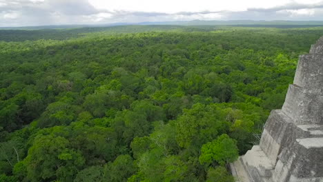 Spectacular-aerial-shot-over-the-treetops-and-Tikal-pyramids-in-Guatemala-3