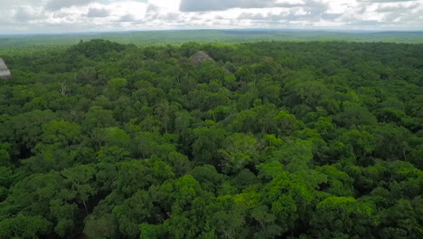 Spectacular-aerial-shot-over-the-treetops-and-Tikal-pyramids-in-Guatemala-5