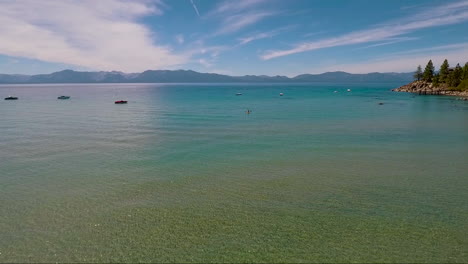 An-aerial-over-a-woman-paddling-a-kayak-across-Lake-Tahoe