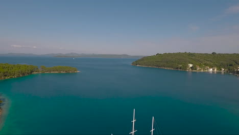 Aerial-over-a-sailboat-sailing-through-the-islands-of--Croatia