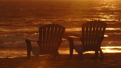 Waves-roll-into-beach-front-Adirondack-chairs