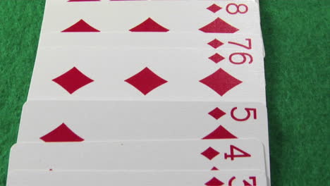 The-camera-moves-across-a-deck-of-cards-laid-out-on-a-casino-table-1