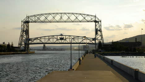 Time-lapse-of-ship-passing-under-lift-bridge-and-bridge-going-back-down