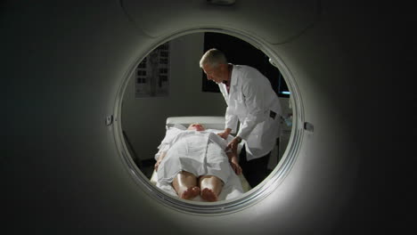 A-doctor-prepares-a-patient-for-a-CAT-scan-3