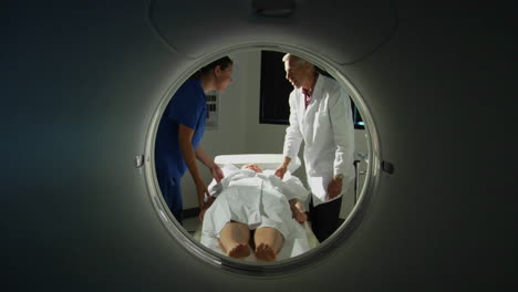 A-doctor-prepares-a-patient-for-a-CAT-scan-4