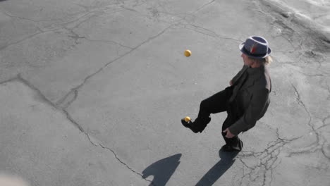 A-man-juggles-two-balls-with-his-feet