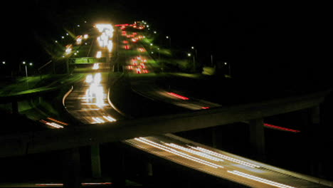 Vehicles-drive-on-a-freeway-at-night-in-fast-motion-4