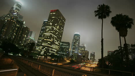 Excellent-shot-of-heavy-traffic-conduciendo-on-a-busy-freeway-in-downtown-Los-Angeles-at-night