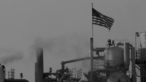 Smoke-moves-across-the-sky-in-an-industrial-area-in-a-black-and-white-shot
