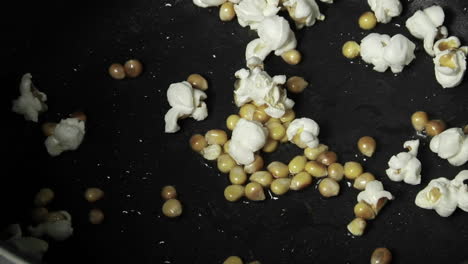 Kernels-of-popcorns-explode-in-a-pan-of-oil