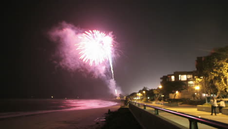 Fireworks-explode-off-a-beach-in-time-lapse