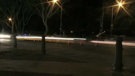 Vehicles-speed-along-a-road-at-night-in-time-lapse