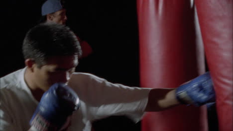 A-couple-of-boxers-work-out-on-punching-bags