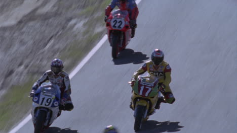 A-group-of-motorcyclists-race-around-a-track