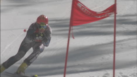 A-skier-skis-down-the-hill-hitting-the-flag-at-the-bottom