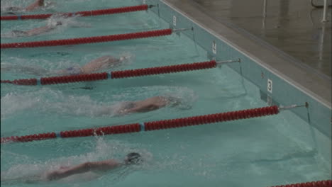 Swimmers-reach-the-side-of-the-pool-turn-around-and-start-back