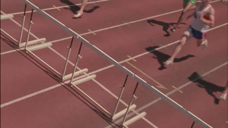 Male-runners-jump-hurdles