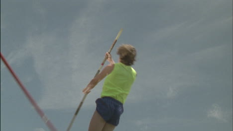 A-person-attempts-a-pole-vault-knocks-the-bar-down-and-falls