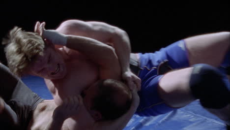 Two-athletes-are-wrestling-on-a-mat