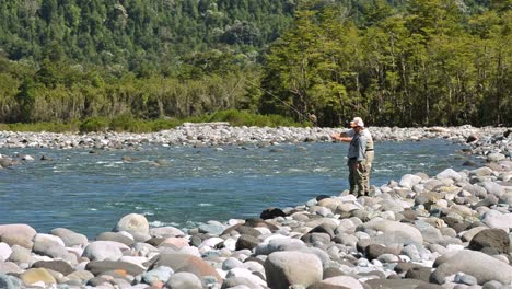 Guest-and-guide-casting-a-fly-fishing-rod-for-trout-on-the-Huequi-River-in-Southern-Chile-1