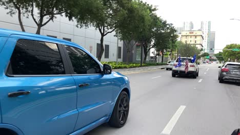 Supporters-of-President-Trump-drive-cars-and-fly-flags-in-a-downtown-city