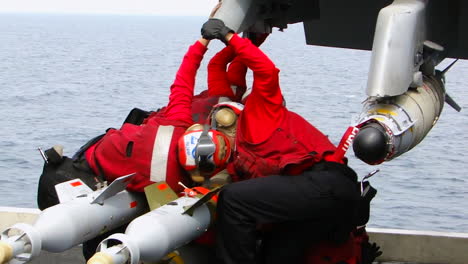 Navy-Men-Load-Warheads-Onto-A-Fighter-Jet-1