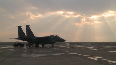 A-F15-Fighter-Jet-Stands-On-A-Runway-Against-Beautiful-Clouds