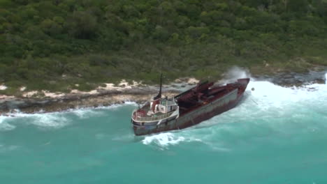 Aerial-Over-A-Shipwreck-With-Huge-Waves-Hitting